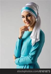 Portrait of muslim woman on grey