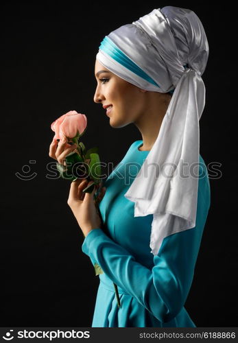 Portrait of muslim woman with rose flower