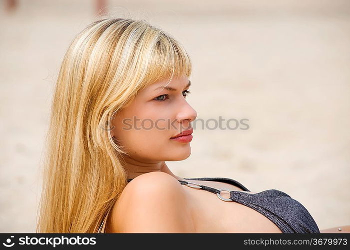 portrait of nice girl looking on one side standing on beach