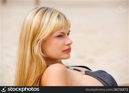 portrait of nice girl looking on one side standing on beach