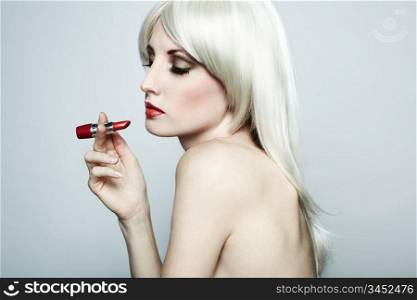 Portrait of nude elegant woman with blonde hair and red lipstick