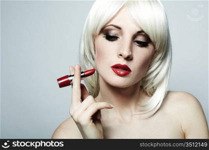Portrait of nude elegant woman with blonde hair and red lipstick