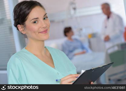 Portrait of nurse holding clipboard