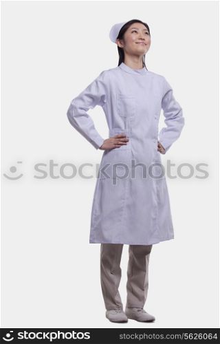 Portrait of Nurse with hands on hips, Studio shot