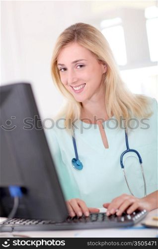 Portrait of nurse working on desktop computer