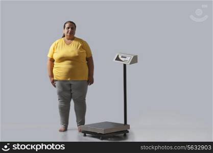 Portrait of obese woman with weighing scale
