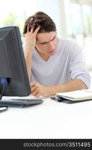 Portrait of office worker having a headache at work