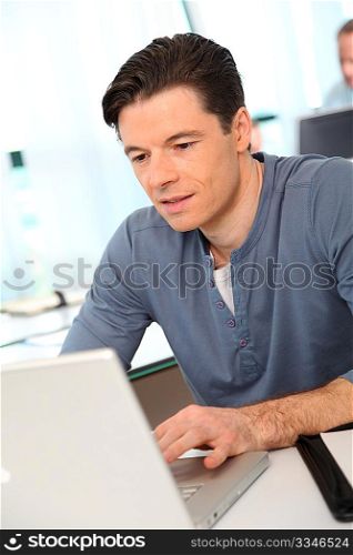 Portrait of office worker in front of laptop computer