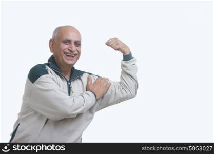 Portrait of old man flexing muscle