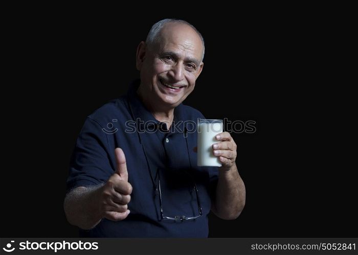Portrait of old man with glass of milk