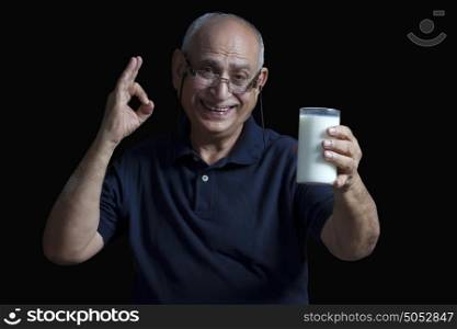 Portrait of old man with glass of milk