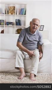 Portrait of old man with pain in knee