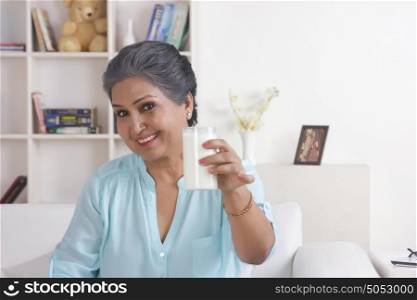 Portrait of old woman with glass of milk
