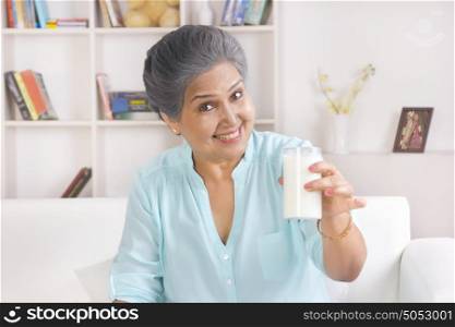 Portrait of old woman with glass of milk