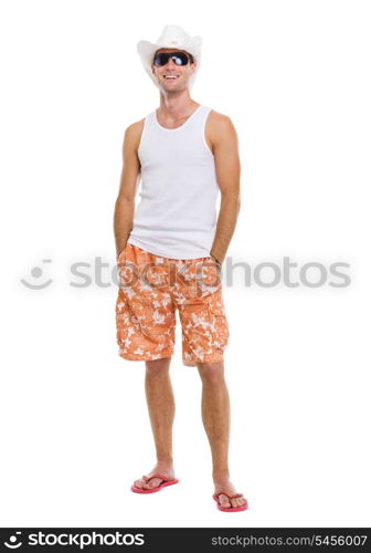 Portrait of on vacation smiling young man in sunglasses and holiday hat