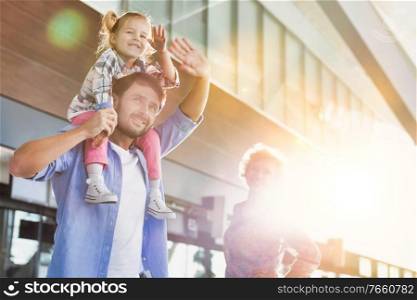 Portrait of one happy family arriving in airport with lens flare