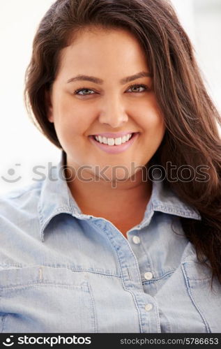 Portrait Of Overweight Woman Sitting On Sofa