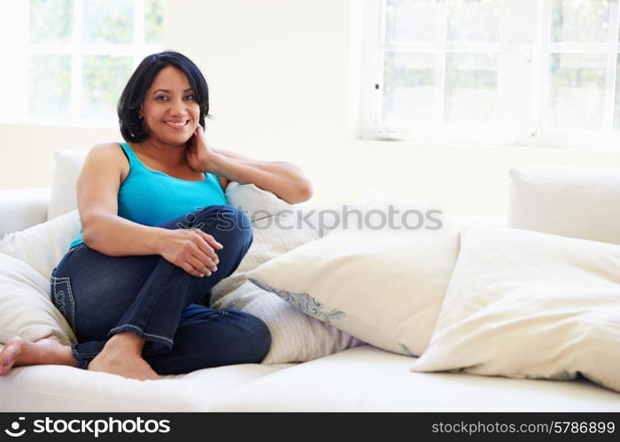 Portrait Of Overweight Woman Sitting On Sofa