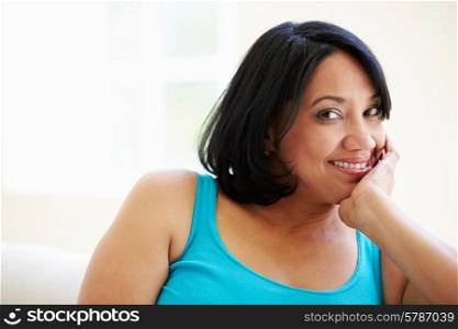 Portrait Of Overweight Woman Sitting On Sofa
