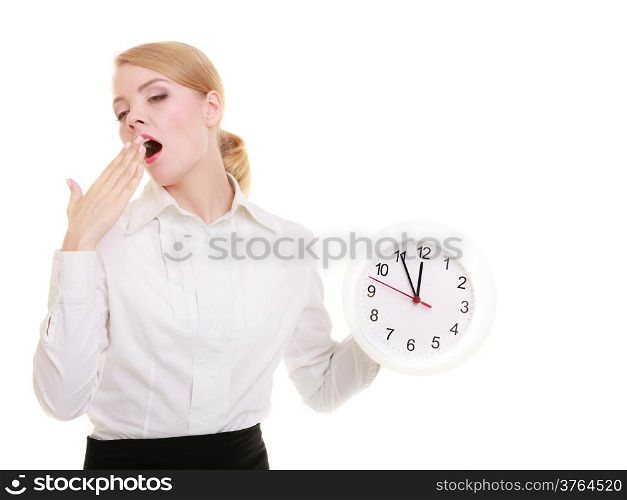 Portrait of overworked businesswoman showing clock. Sleepy blond girl yawning isolated on white. Time management and long working hours. Studio shot.