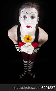Portrait of pantomime actor in with yellow gerberas