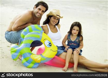 Portrait of parents and their daughter on the beach