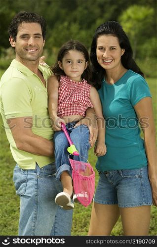 Portrait of parents and their daughter smiling