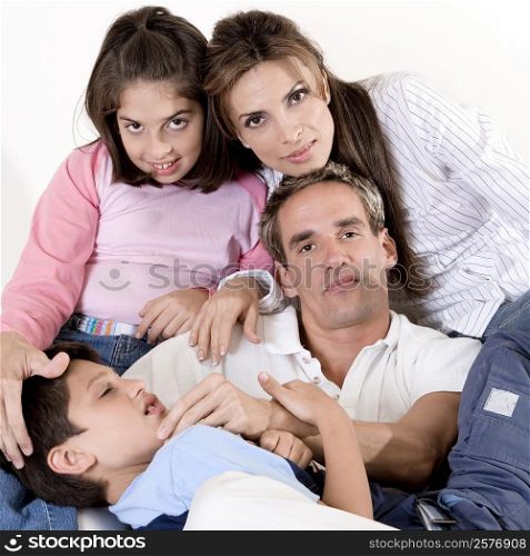 Portrait of parents sitting with their son and daughter