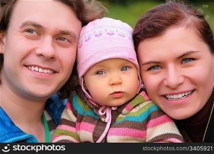 Portrait of parents with baby on nature