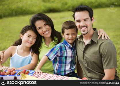 Portrait of parents with their son and daughter smiling