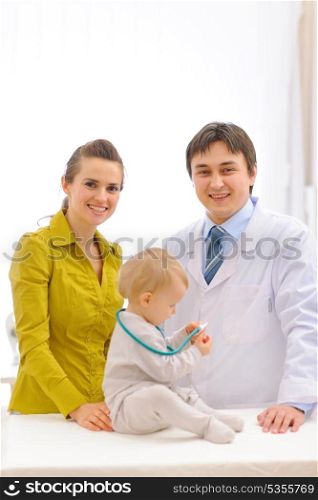 Portrait of pediatrician doctor and mother with baby on examination