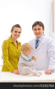 Portrait of pediatrician doctor and mother with baby on examination