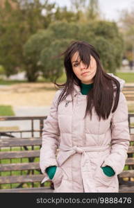 Portrait of pensive urban girl walking in city park