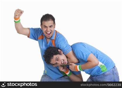 Portrait of playful young male friends in jerseys isolated over white background
