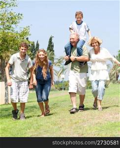 portrait of playfull family running towards camera