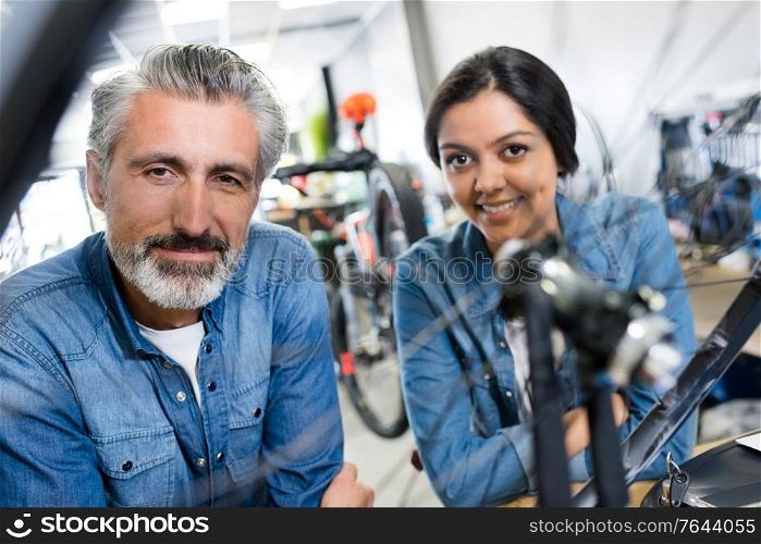 portrait of positive woman hiring bikes on rental store