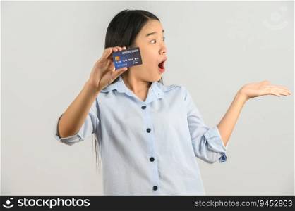 Portrait of positive young asian woman showing credit card good mood salary isolated on white background. Finance, currency, payment and people concept.