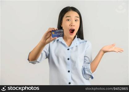 Portrait of positive young asian woman showing credit card good mood salary isolated on white background. Finance, currency, payment and people concept.