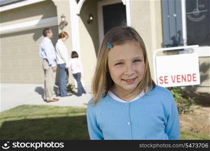 Portrait of pre-teen girl (7-9) in front of new house