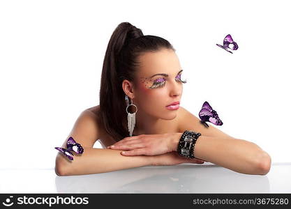 portrait of pretty and sensual brunette with hair tail and creative make up with long eyelashes and butterflys