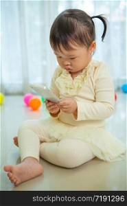 Portrait of pretty asian little girl talking on mobile phone