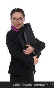 portrait of pretty bespectacled businesswoman holding briefcase