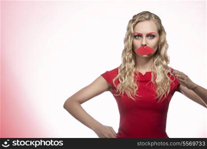 portrait of pretty blonde girl posing like a puppet with fake red mouth and eyebrows and long wavy hair. Photo booth