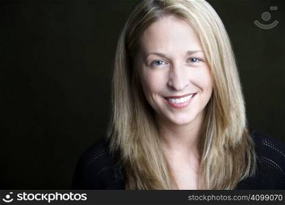 Portrait of pretty blonde woman on a dark background