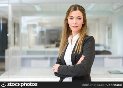 Portrait of pretty businesswoman looking at camera in an office