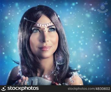 Portrait of pretty female wearing stylish crystal jewelery over dark snowy background, gorgeous snow queen looking up, fashion and beauty