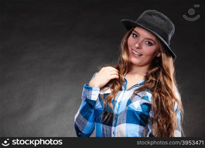 Portrait of pretty gorgeous woman. Attractive young girl with long hair wearing hat and checked shirt. Country style fashion.