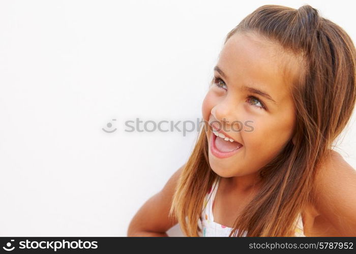 Portrait Of Pretty Hispanic Girl Standing By Wall