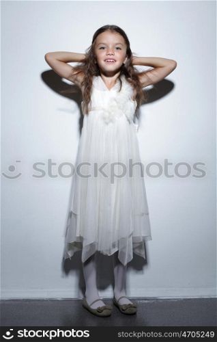 portrait of pretty little girl in white dress