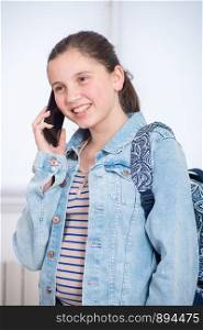 portrait of pretty schoolgirl using phone
